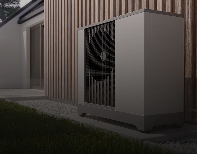 Wärmepumpe vor einem Haus im Garten